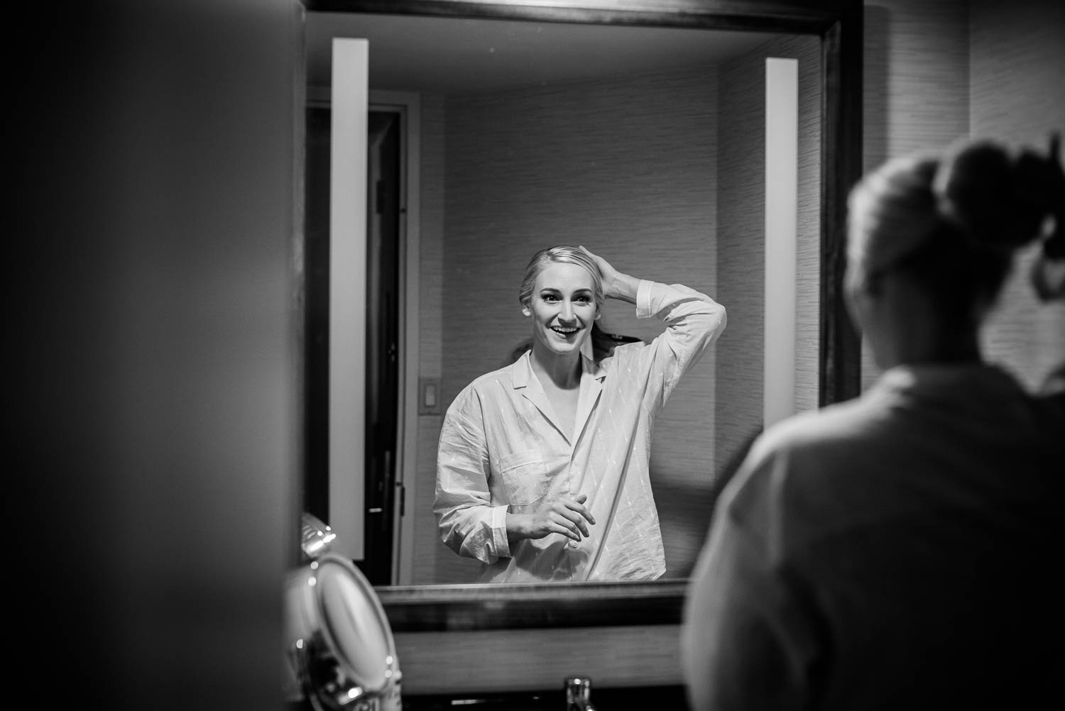 Bride getting ready in mirror at the Hyatt Regency Houston, Texas.