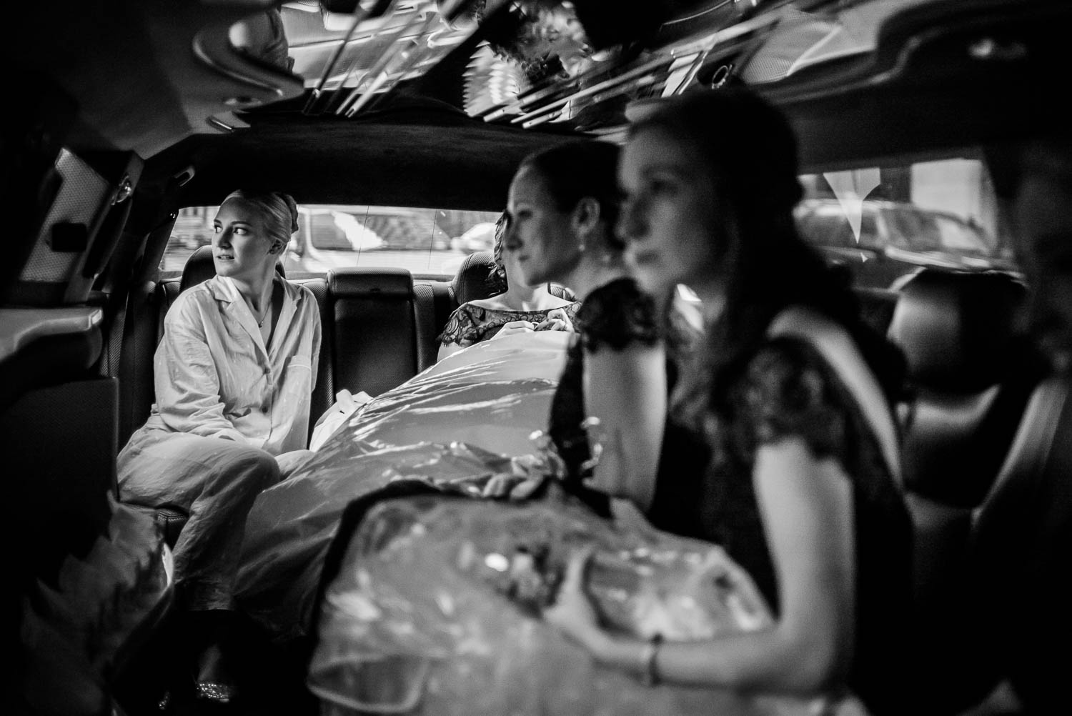 Bride in limo looks out of the window after leaving the Hyatt Regency en route to First United Methodist Church, Houston Texas