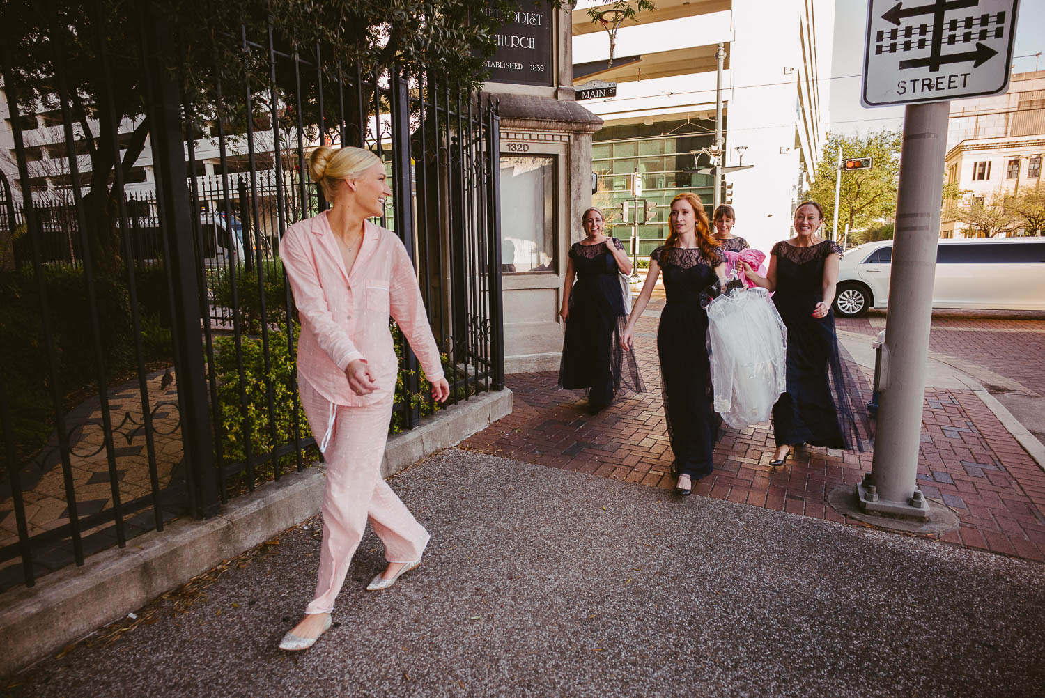 Bride looks over at bridesmaids as she enters United Methodist Church, Houston.