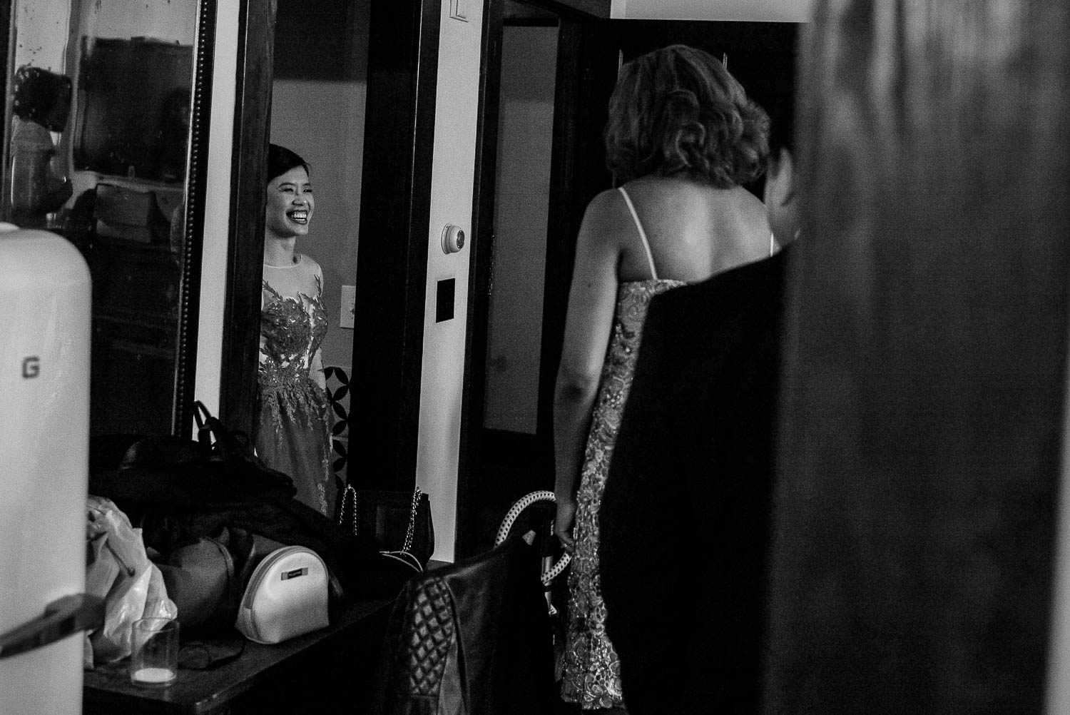 A bride enters room in her dress before her friends at Hotel Havana Wedding getting ready wedding - Leica photographer-Philip Thomas Photography