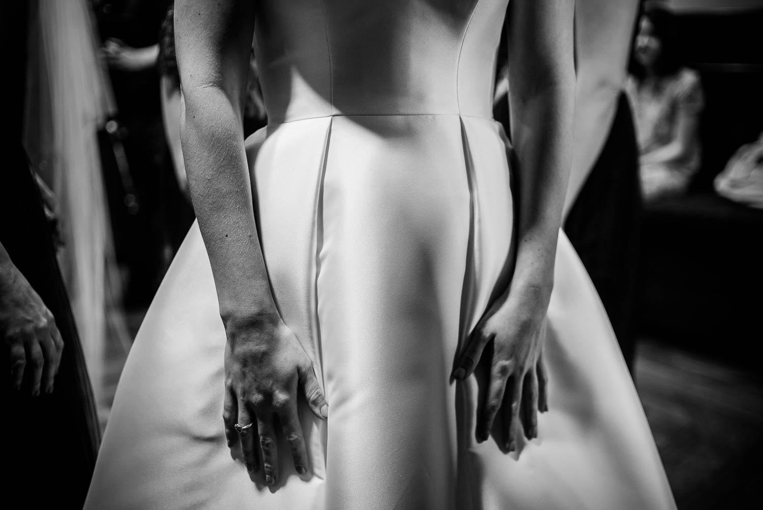 Abstract look at brides hands and her bridal gown at United Methodist Church, Houston Texas