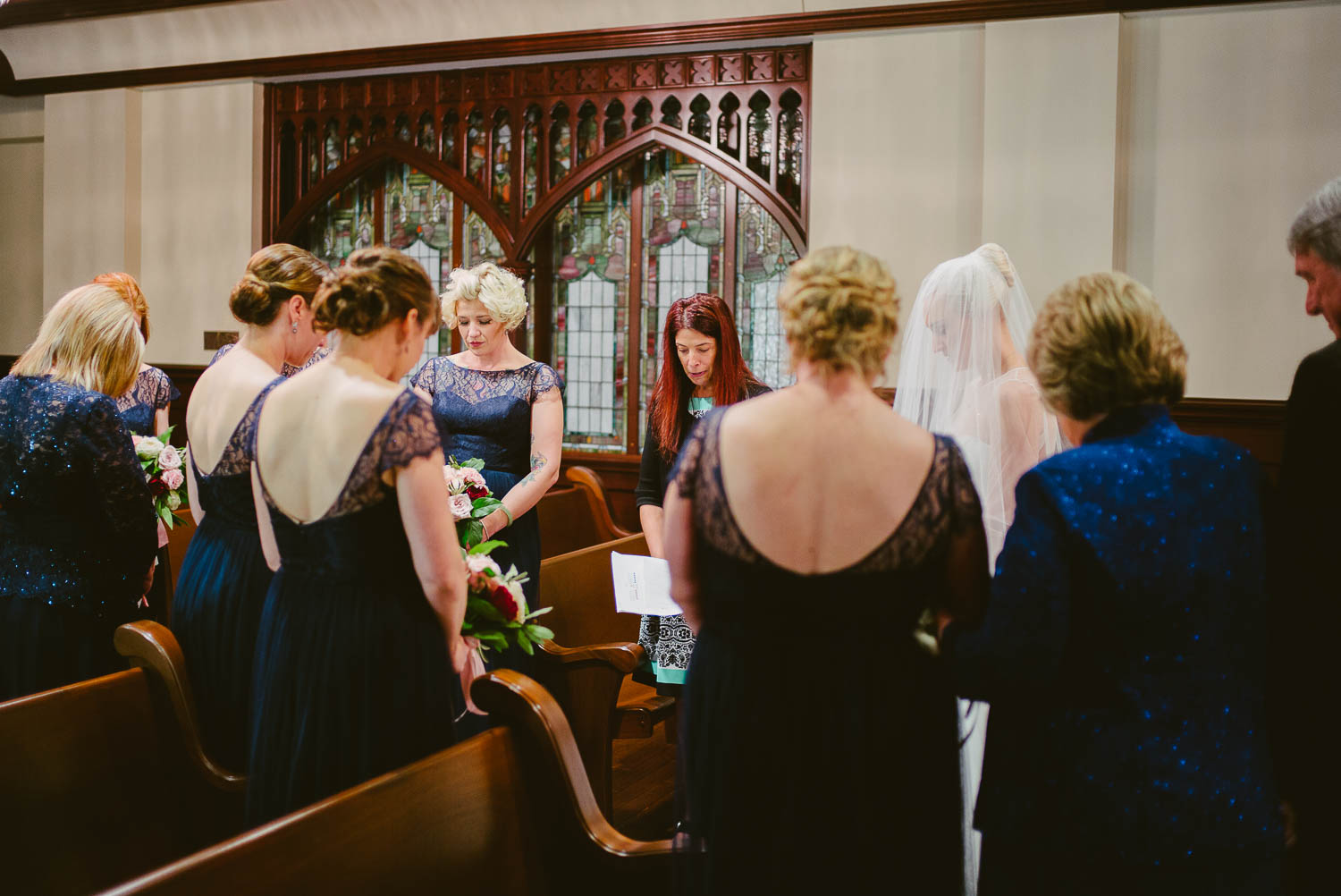 A prayer is held with immediate friends and family with the bride at United Methodist Church moments before the ceremony