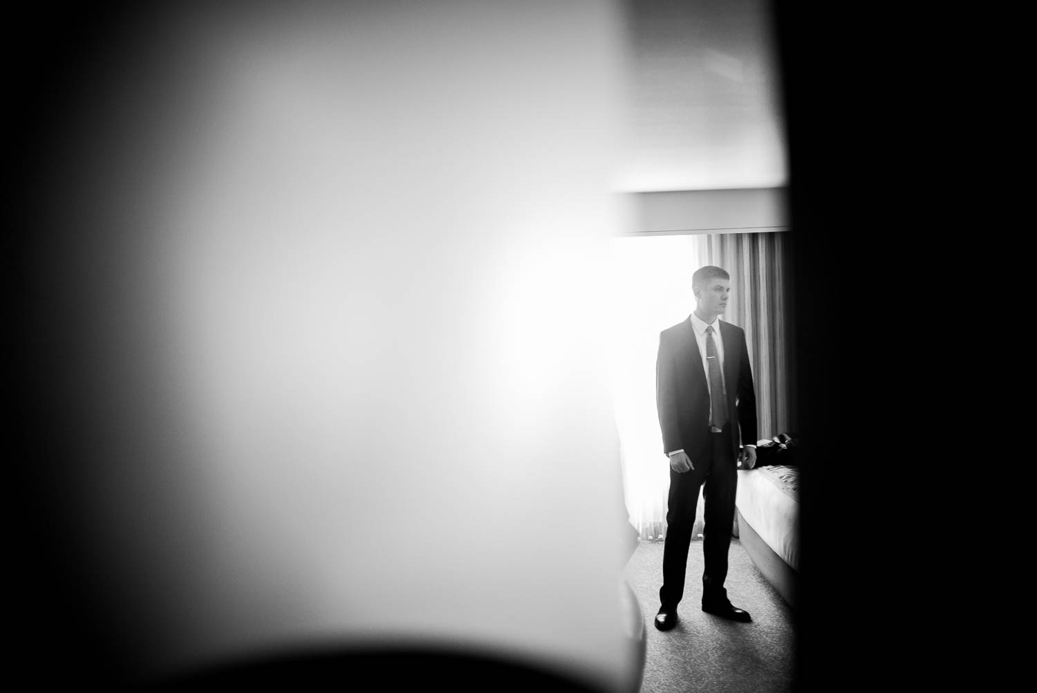 Groom dressed inside doorframe at 1909 Topanga California Wedding-Leica-Philip Thomas