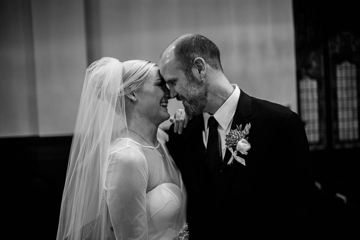 Just married couple forehead to forehead at irst United Methodist Church Wedding Houston