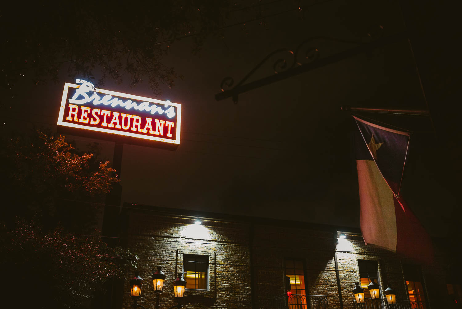 A nigh time shot wedding reception Brennan's of Houston, Texas. showing the Texas flag.