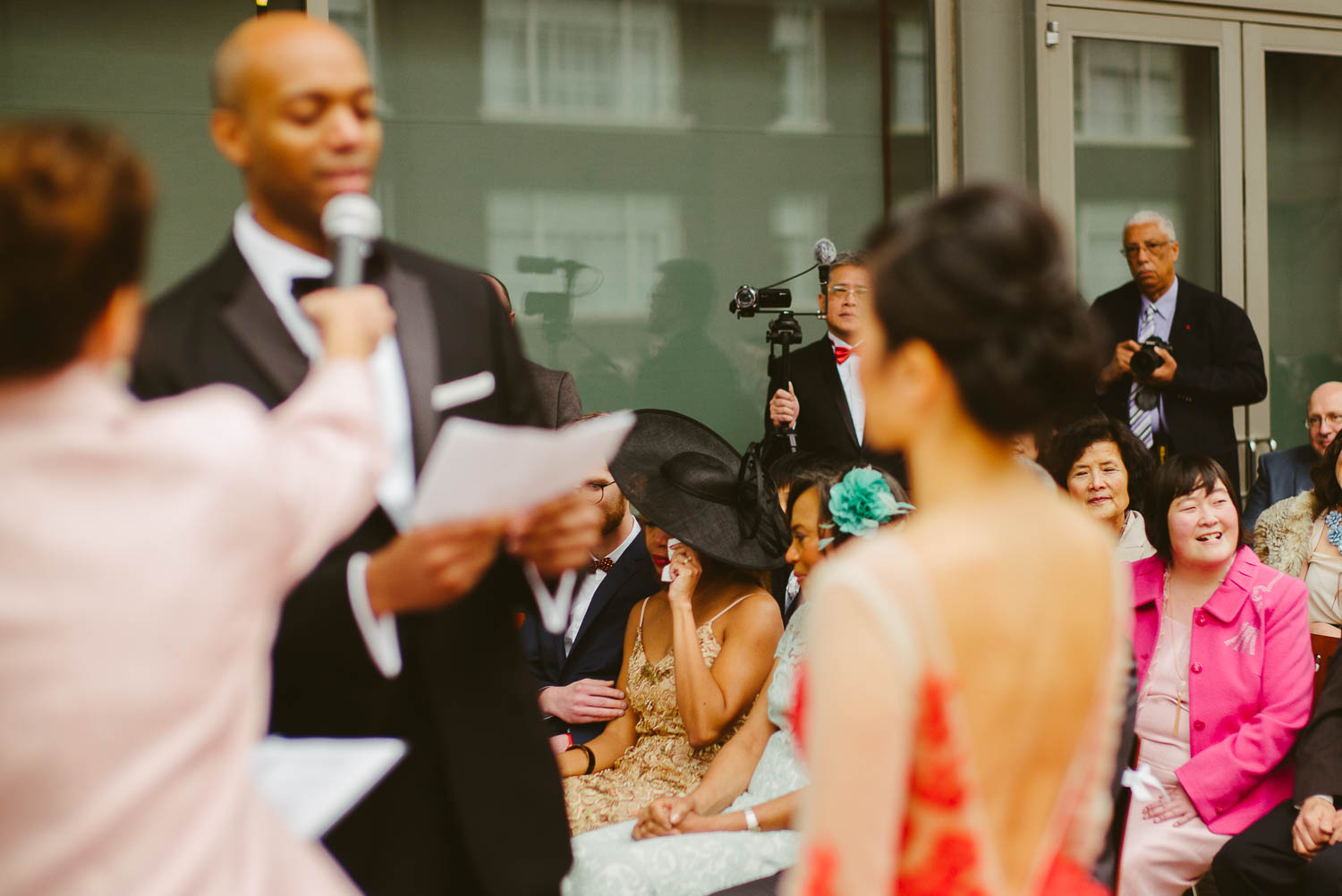 Sister of the groom wipes a tear as grrom shares a few words during wedding ceremony at La Orilla Del Rio Ballroom-Leica photographer-Philip Thomas Photography