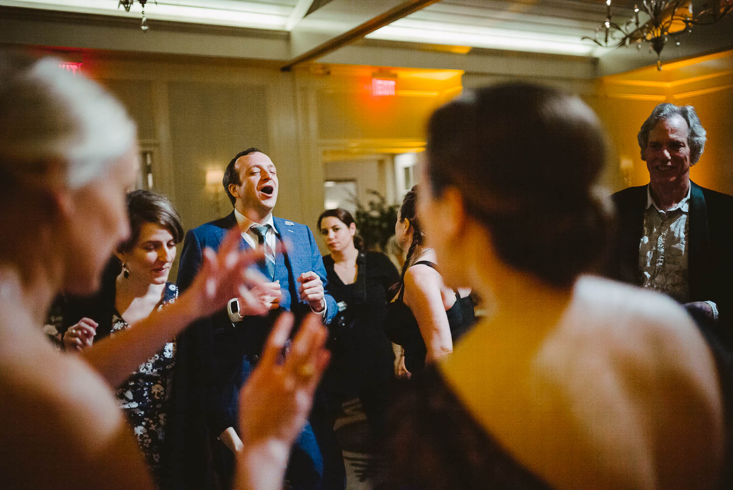 Chicago friend of the bride and groom shouts out during a wedding reception at wedding reception Brennan's of Houston, Texas.