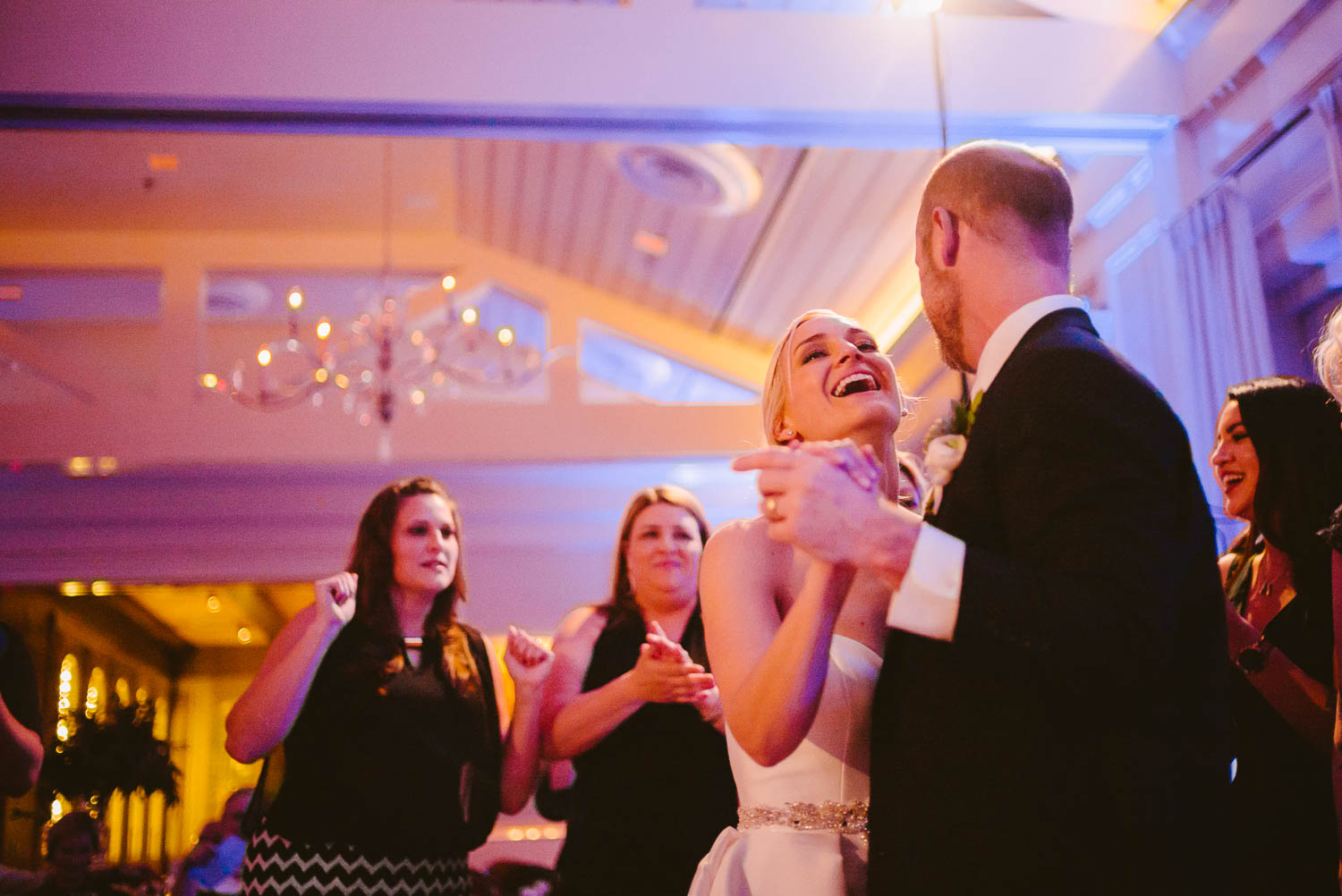 Wed couple on reception floor in joyful moment wedding reception Brennan's of Houston, Texas.
