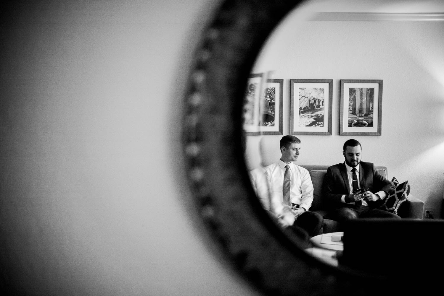 Groom and friend relax on sofa shot with mirror reflection at 1909 Topanga California Wedding-Leica-Philip Thomas