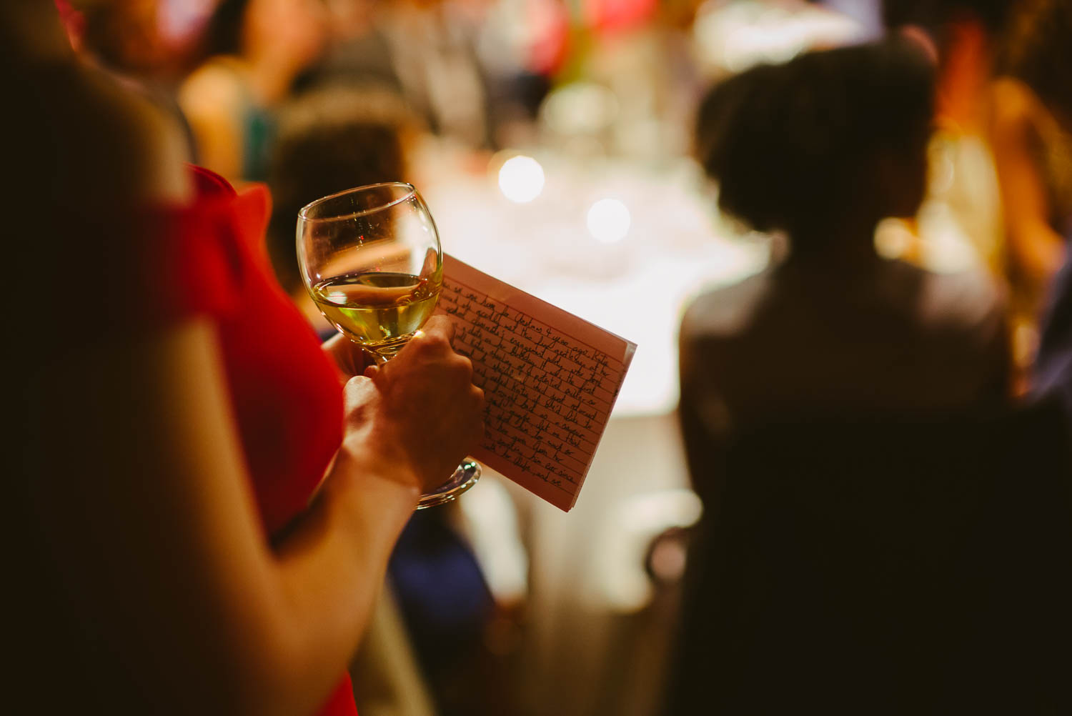 Sister of the bride holds her speech card preparing for toasts at a wedding reception La Orilla Del Rio Ballroom-Leica photographer-Philip Thomas Photography