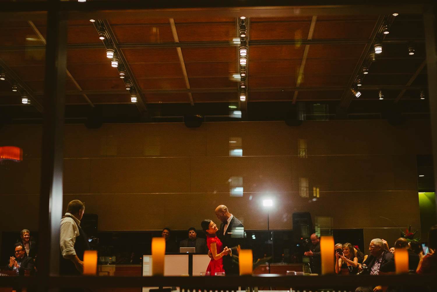 Couples first dance shot behind glass with available light at La Orilla Del Rio Ballroom-Leica photographer-Philip Thomas Photography