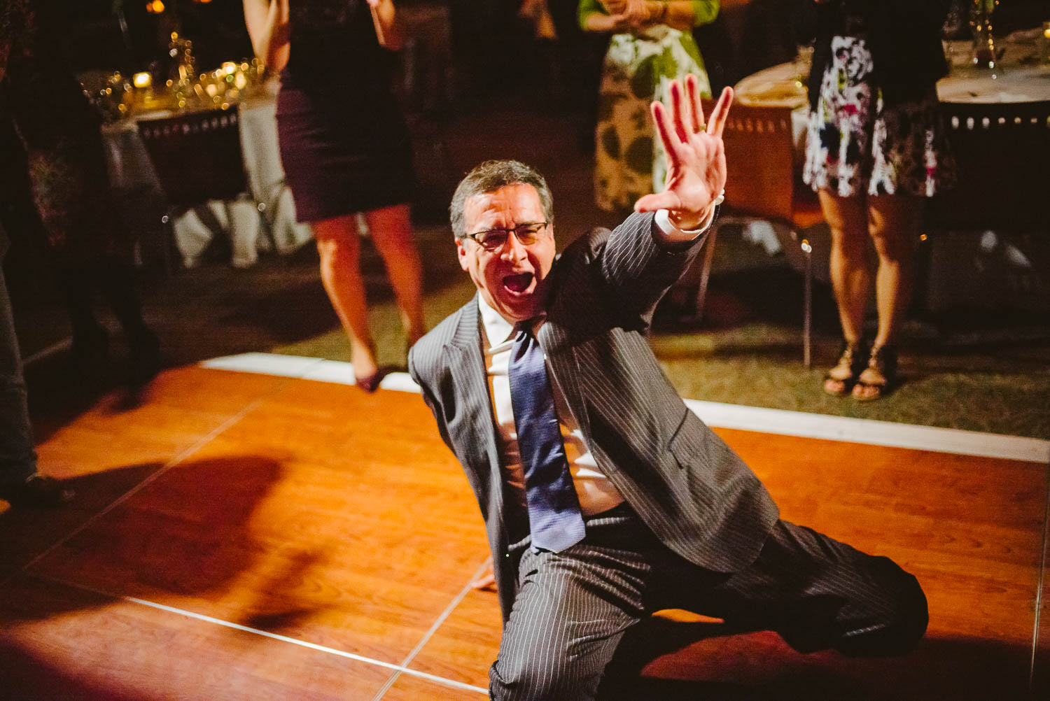 Guest makes his go to move on the wood floor at a wedding reception Orilla Del Rio Ballroom-Leica photographer-Philip Thomas Photography