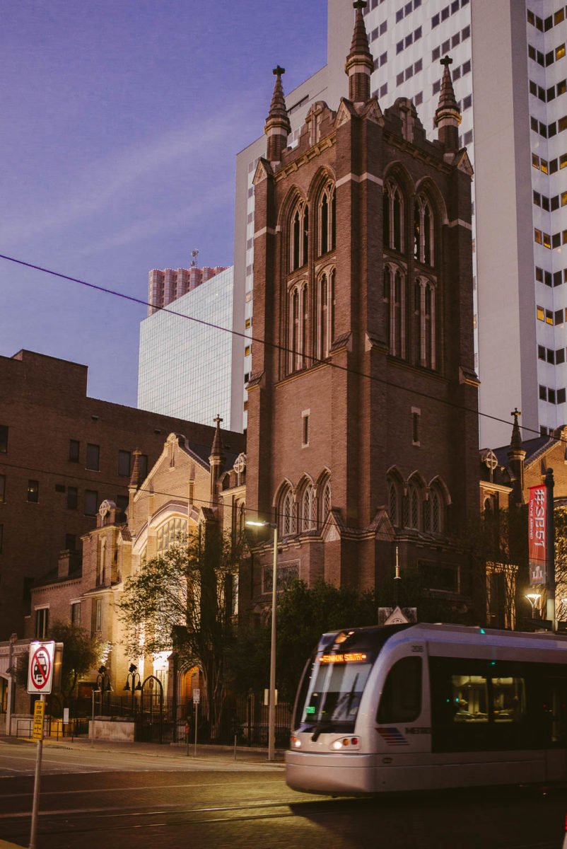 Exterior photo of First Methodist Church 1320 Main Street Houston showing street tram pass in foreground