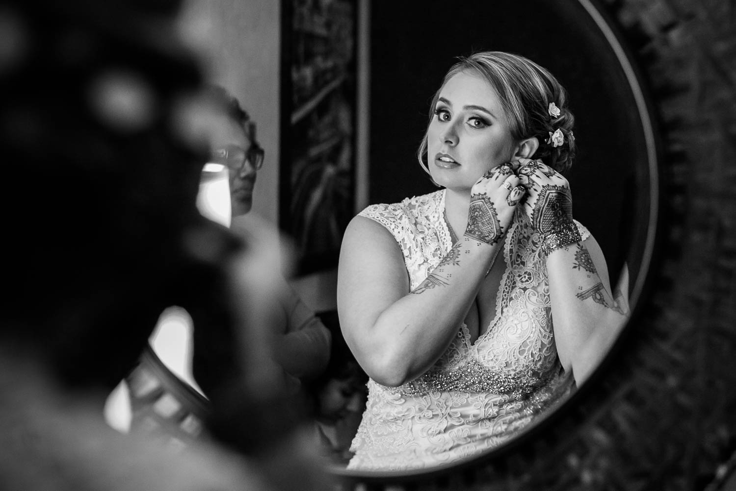 Bride wears ear rings on her wedding day at Drury inn and Suites San Antonio Texas