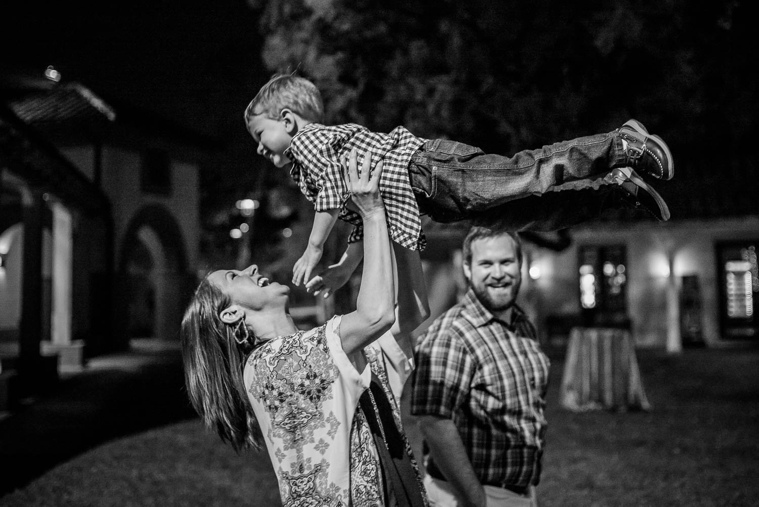 Mother and father play with their son at a wedding reception The-Witte_Museum-Leica-wedding-photographer-Philip Thomas Photography