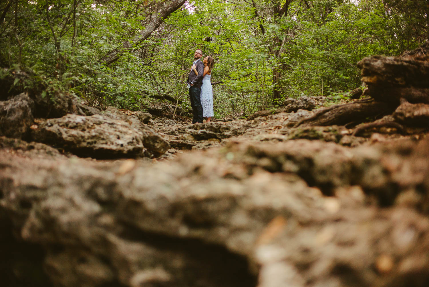 Balcones District Park couple Ashley and Fred standing in flash flood rocky area Austin Engagement Downtown