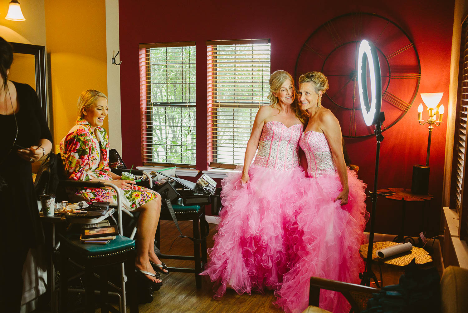 In a humorous moments mothers of the bride and groom dress in Quinceanera dresses as bride laughs The Gardens of Old Town Helotes Hill Country Wedding