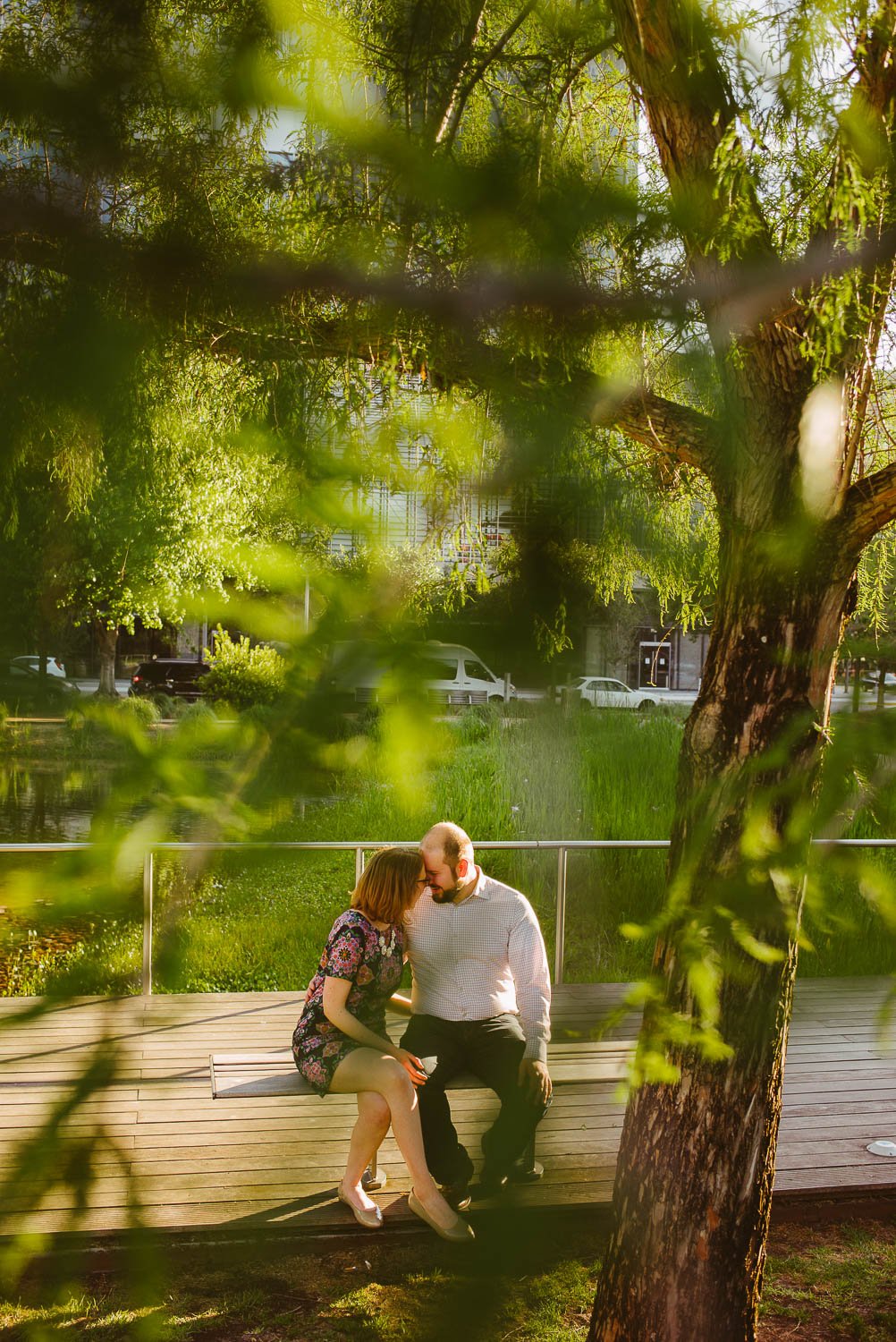 Couples engagement shoot sit on park bench at Discovery Green Houston -Philip Thomas Photography