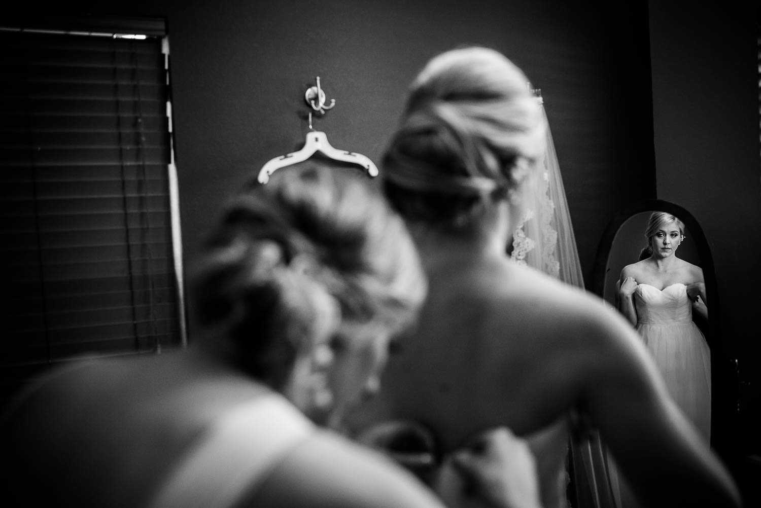 Jessica checks the mirro as she buttons up the bridal dress The Gardens of Old Town Helotes Hill Country Wedding