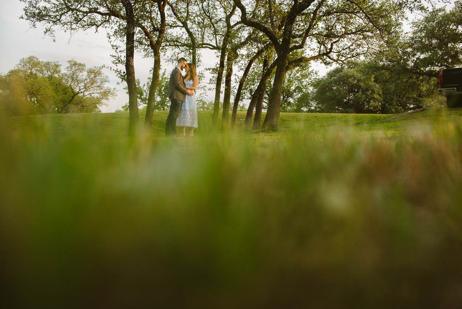 Engaged couple in wooded meadow at Balcones District Park Engagement Session