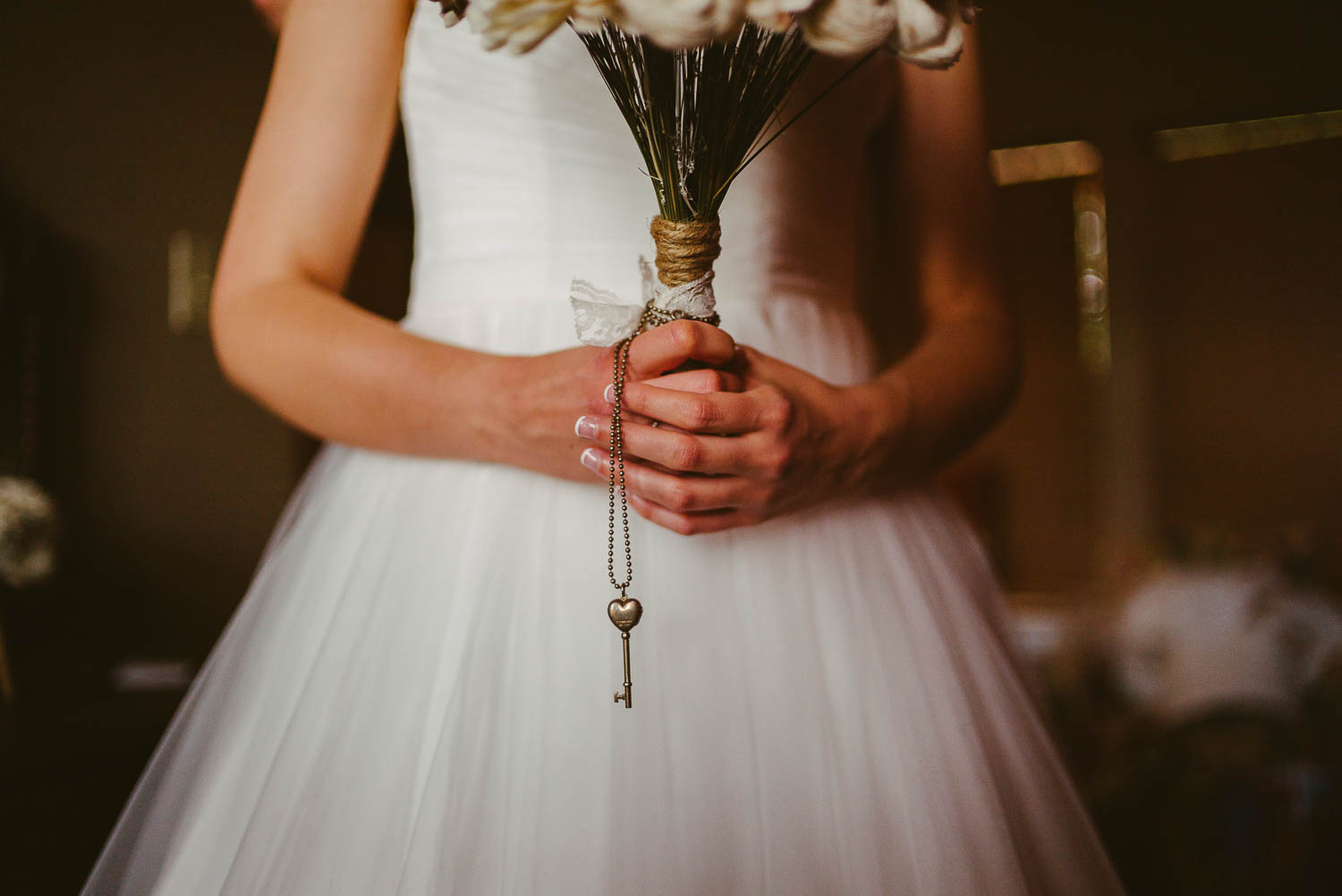 Image of bride holding bouquet and heirloom necklace close up of hands at The Gardens of Old Town Helotes Hill Country Wedding