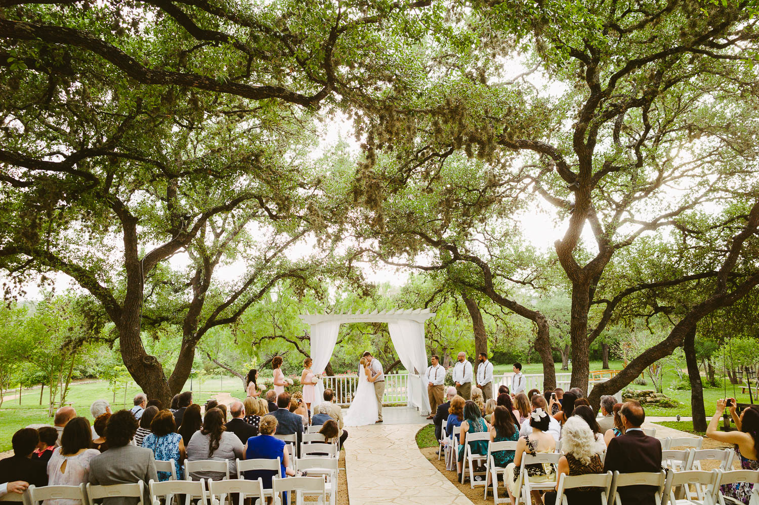 Wide shot of wedding ceremony at he Gardens of Old Town Helotes Hill Country Wedding