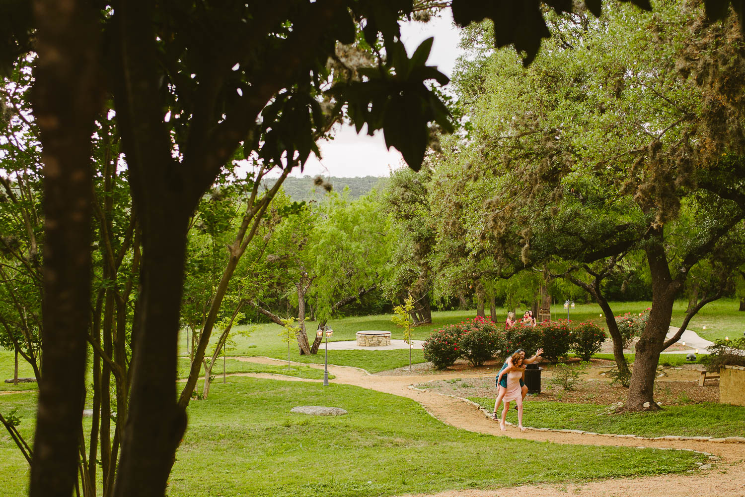 Wide angle of girls giving a piggy back ride -The Gardens of Old Town Helotes Hill Country Wedding