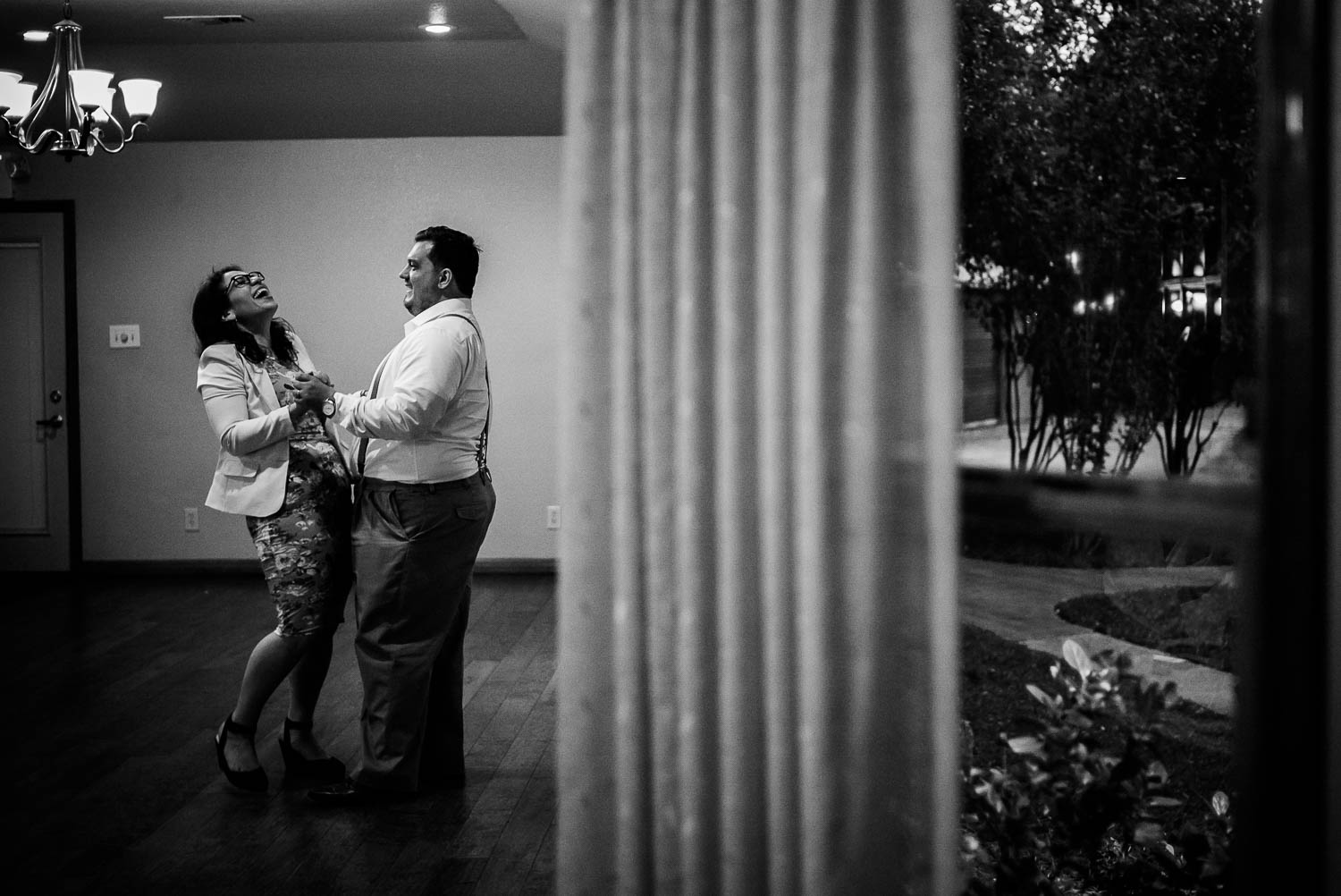 Couple unaware of the camera dance and laugh wedding reception-The Gardens of Old Town Helotes Hill Country Wedding