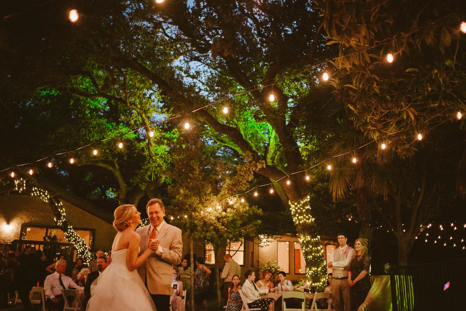 Jessica dances iwth her father first dance with beautiful light strings across reception at The Gardens of Old Town Helotes Hill Country Wedding