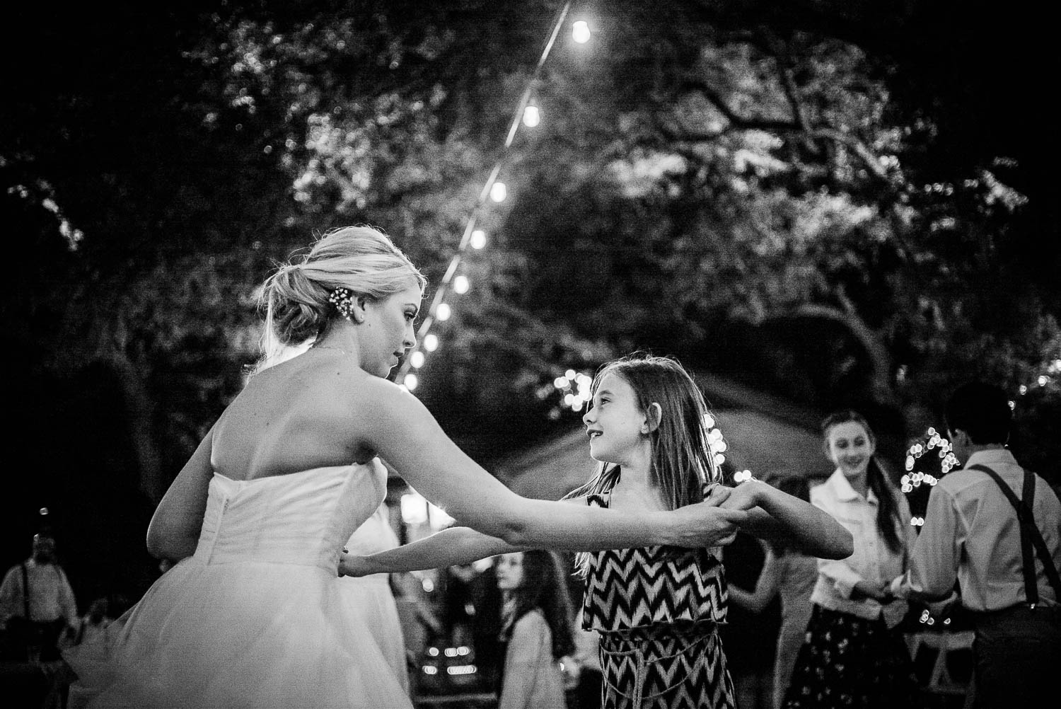 Girl dances with bride -The Gardens of Old Town Helotes Hill Country Wedding