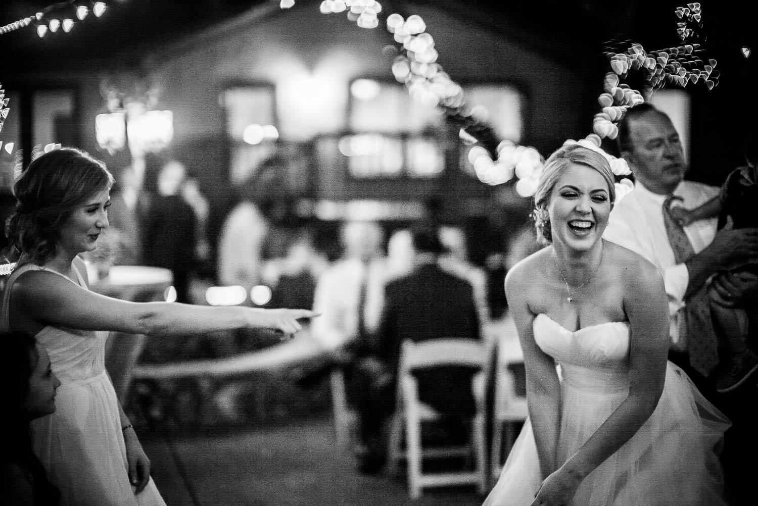 Brides laughs with sister at wedding reception -The Gardens of Old Town Helotes Hill Country Wedding