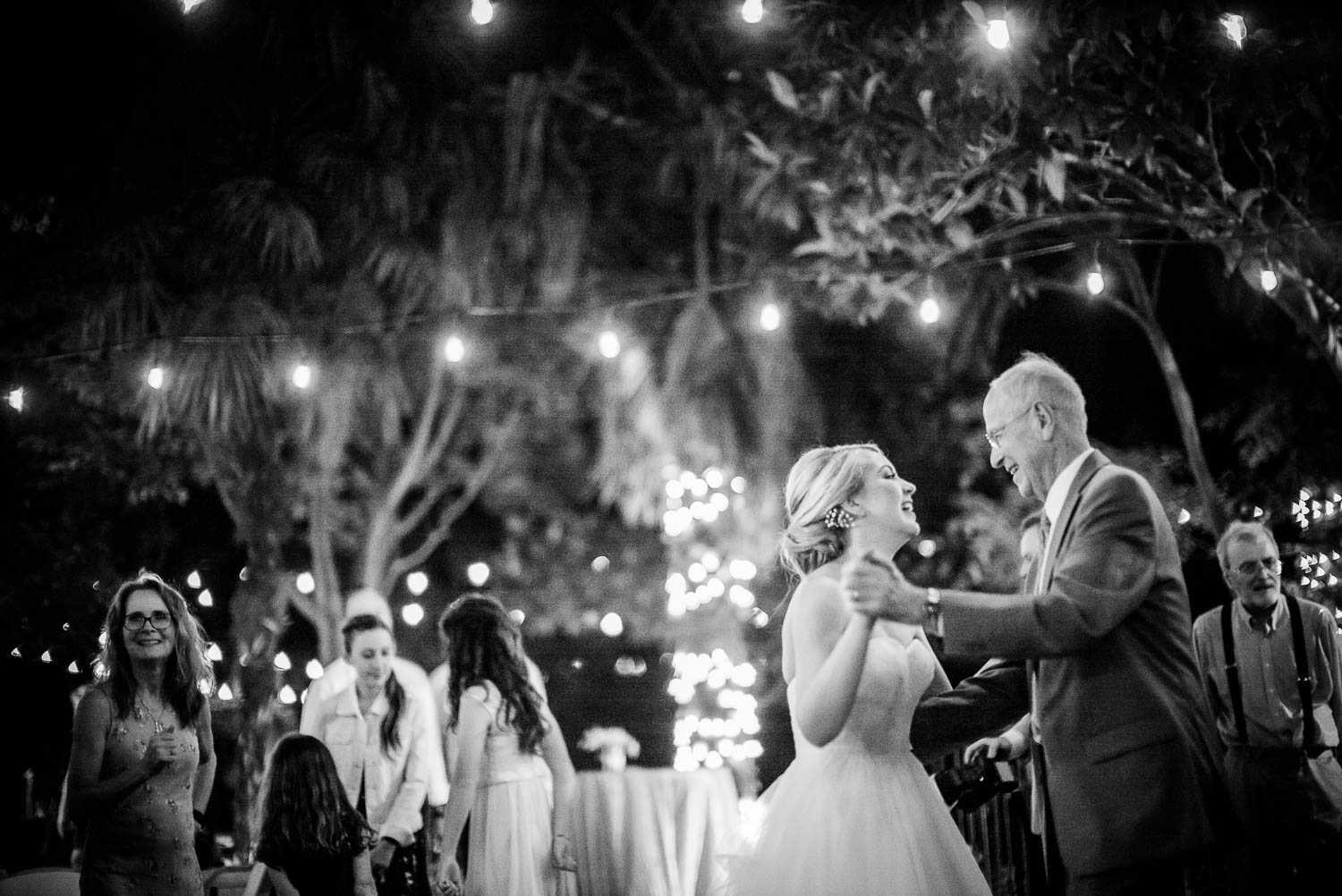 Gorgeous light with the Noctilux 0.9 as bride dances with grandfather The Gardens of Old Town Helotes Hill Country Wedding