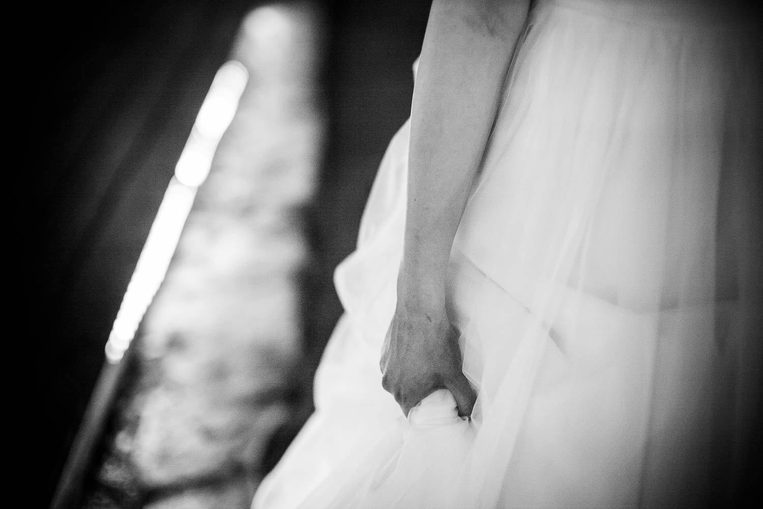 Bride clutches her wedding dress at The Gardens of Old Town Helotes Hill Country Wedding