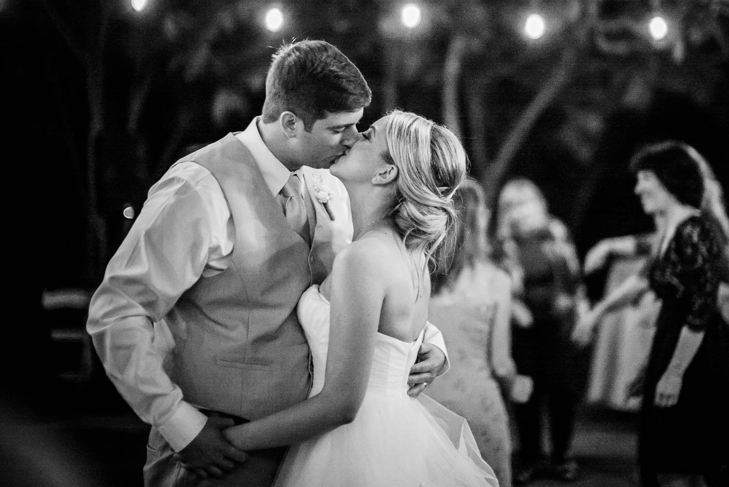 Couple kiss during wedding reception dancing in the hill country The Gardens of Old Town Helotes Hill Country Wedding