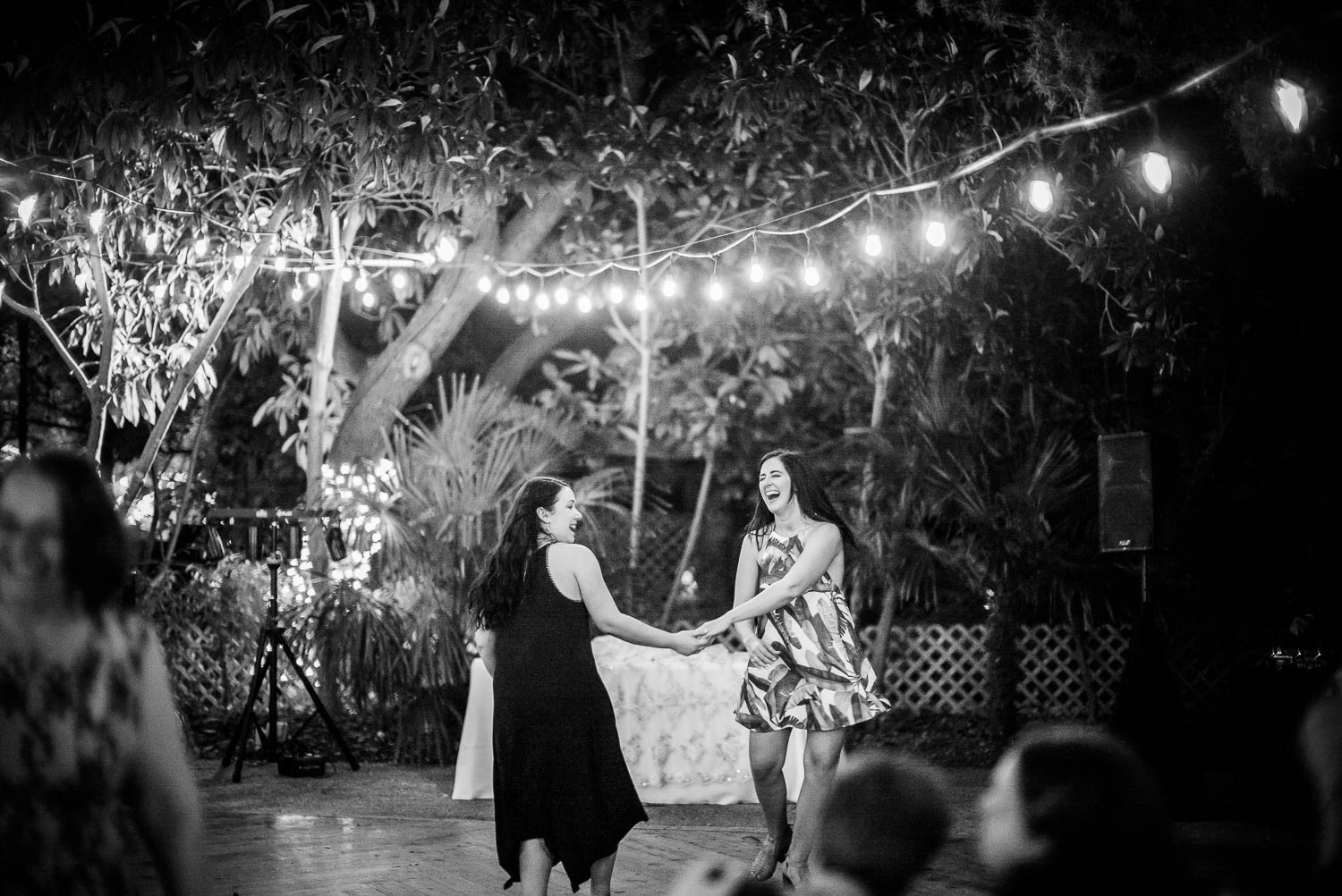 Two guests dancing at a spring wedding reception The Gardens of Old Town Helotes Hill Country Wedding