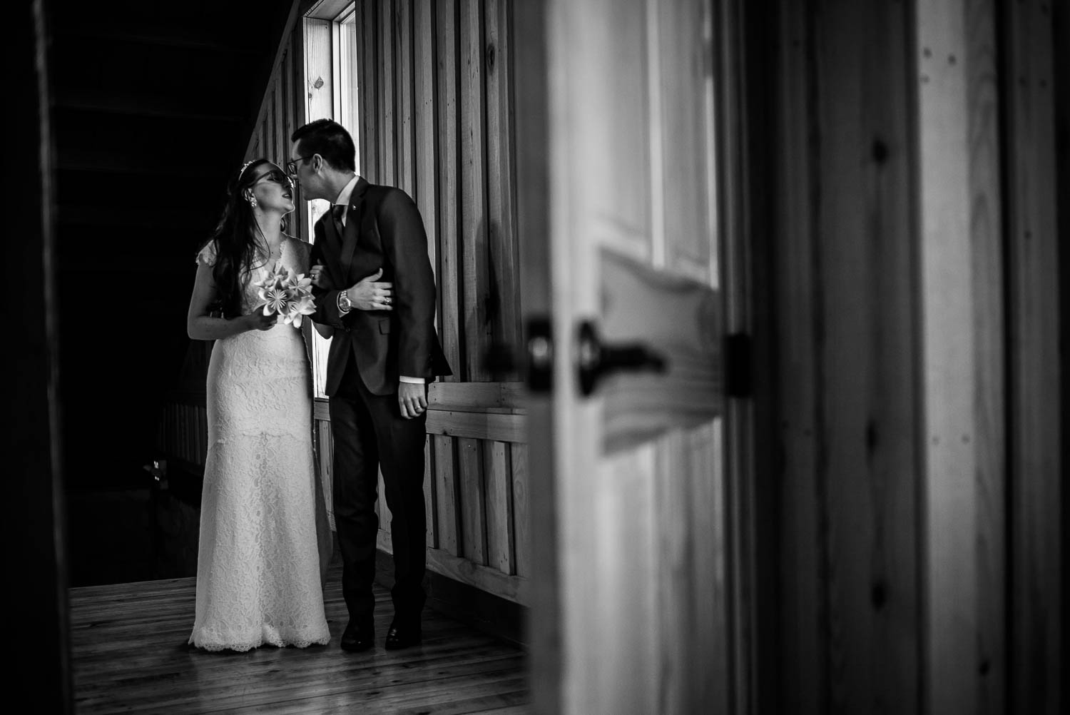 Couple sneek a kiss moments before entering wedding reception Pecan Springs Houston Texas photo by Philip Thomas Photography