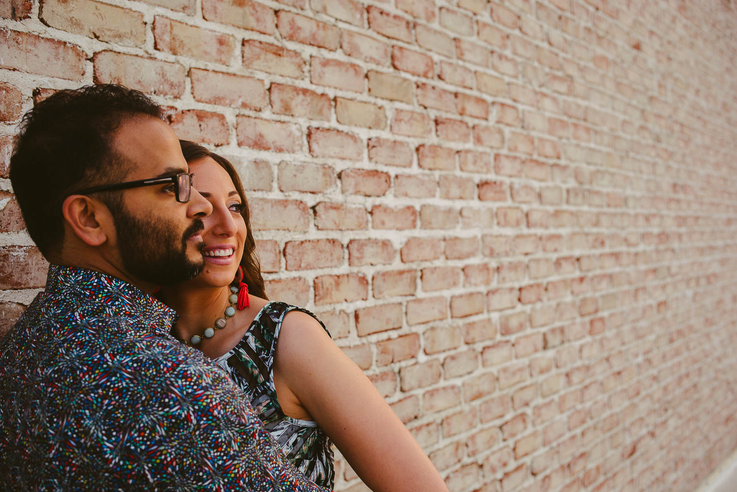 Early morning light on engaged couples faces at The Astorian Houston