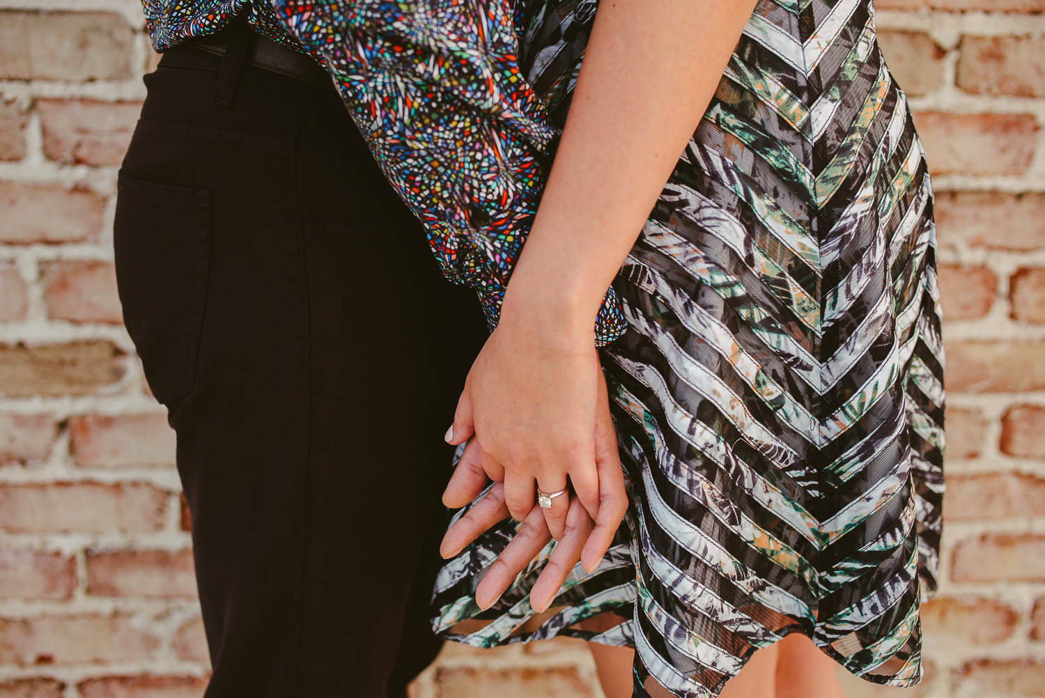 Couple holding hands closeup at The Astorian Houston texas