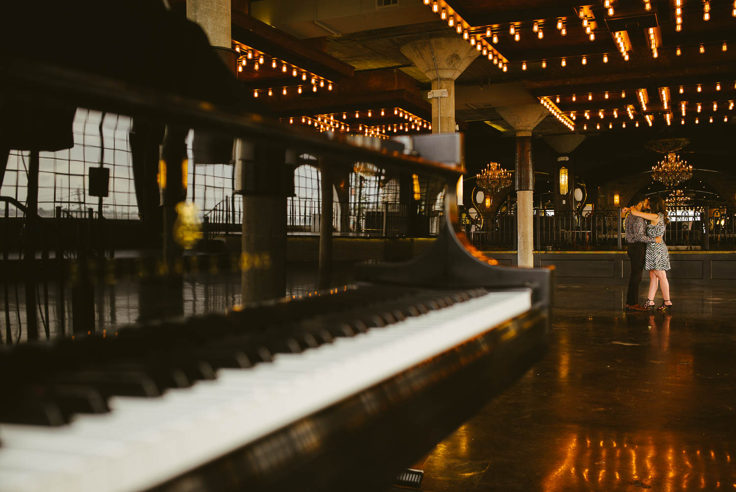 Couple engagement session with Steinway Piano in foreground