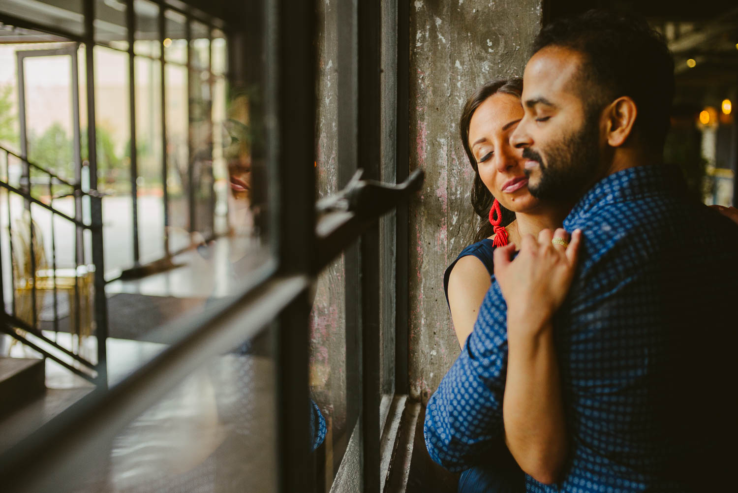 Couple near window at The Astorian engagement session