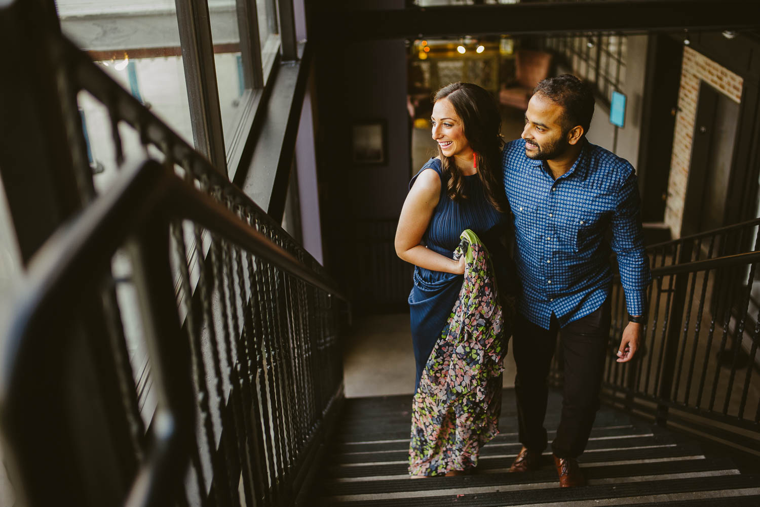 Couple look at skyline during engagement session at The Astorian Houston Texas