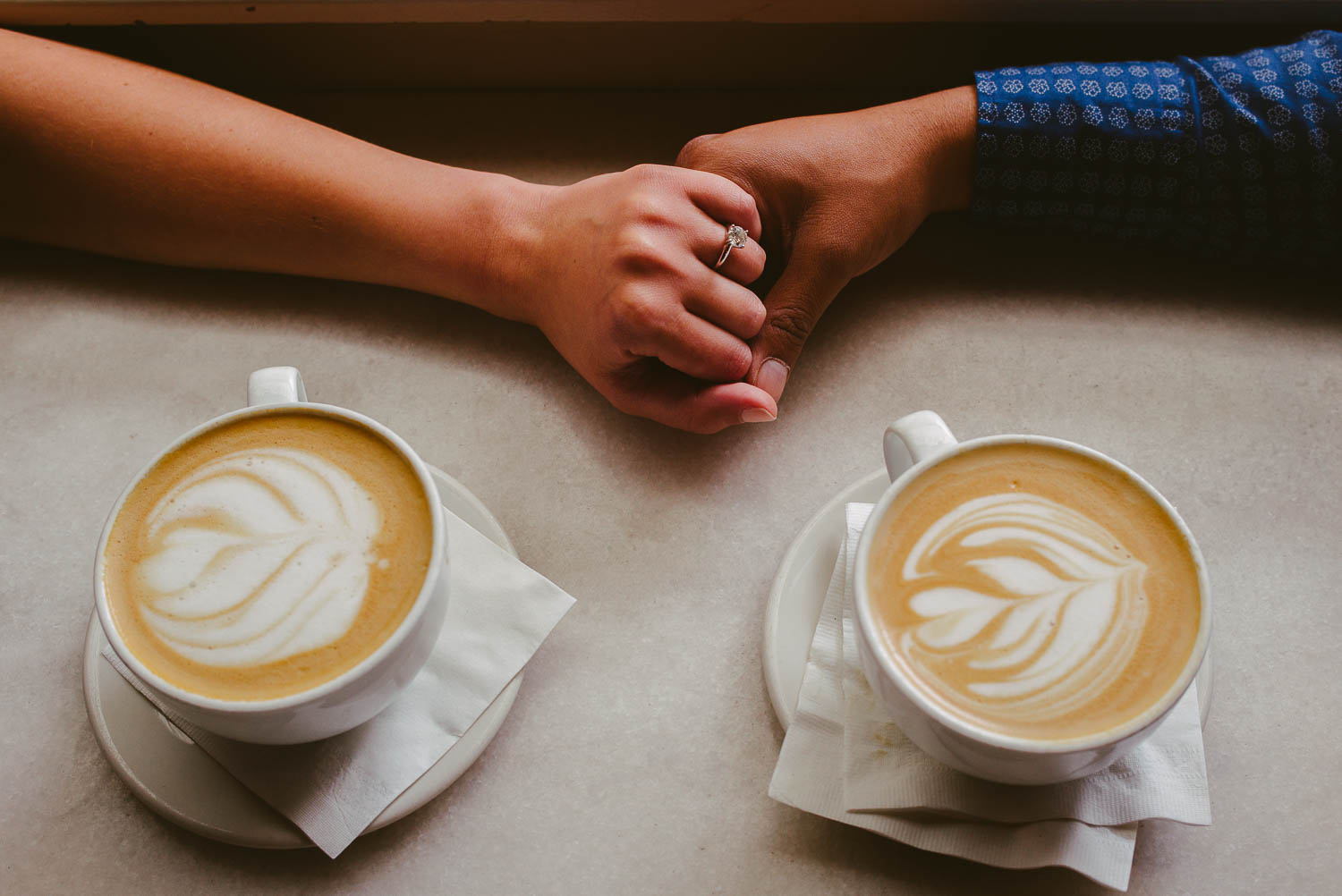 Holding hands with coffeee at Honeymoon Cafe Houston Texas