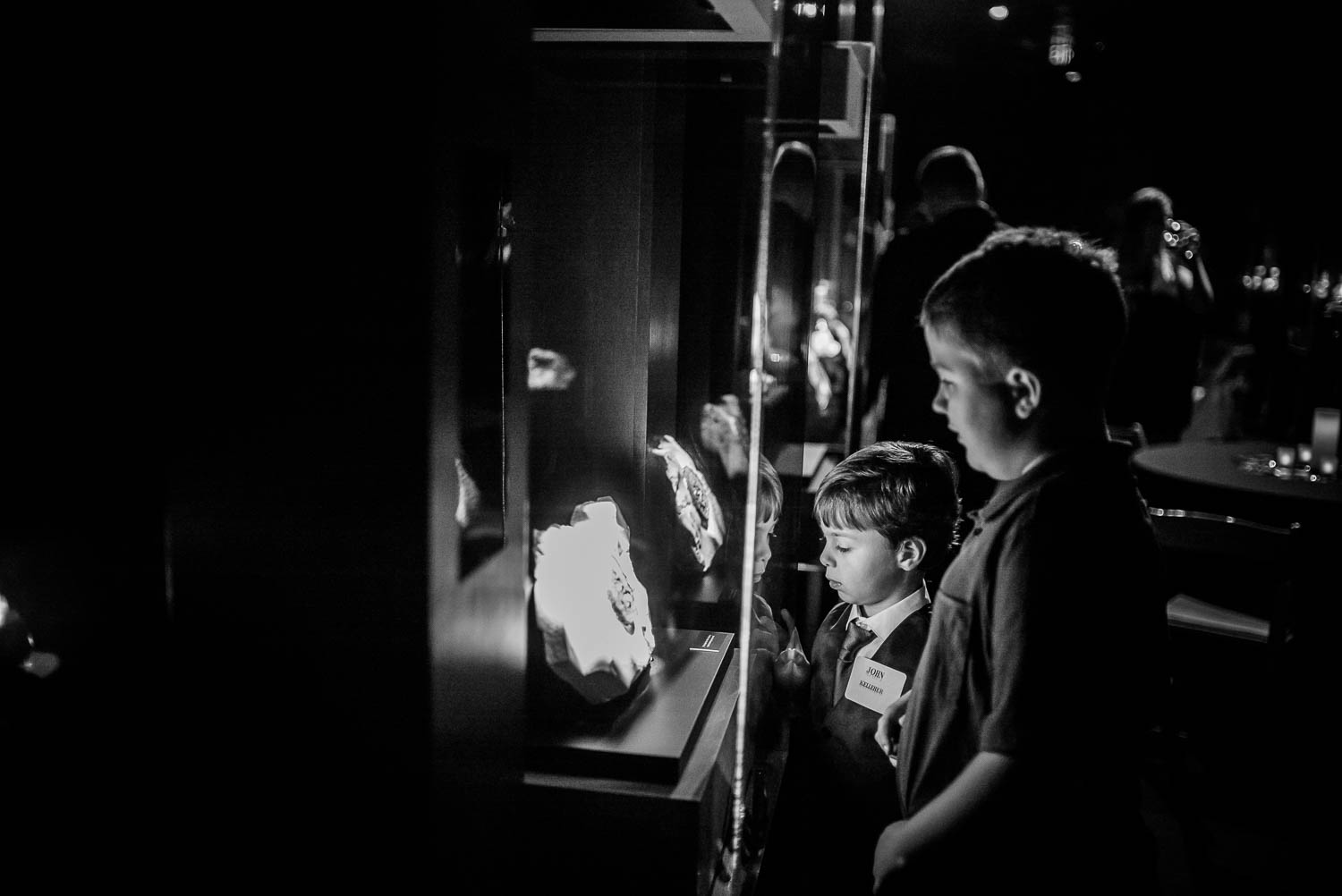 Two boys gawk at display cabinet Rehearsal dinner dinosaur image at Houston Museum of Natural Science by Philip Thomas Photography