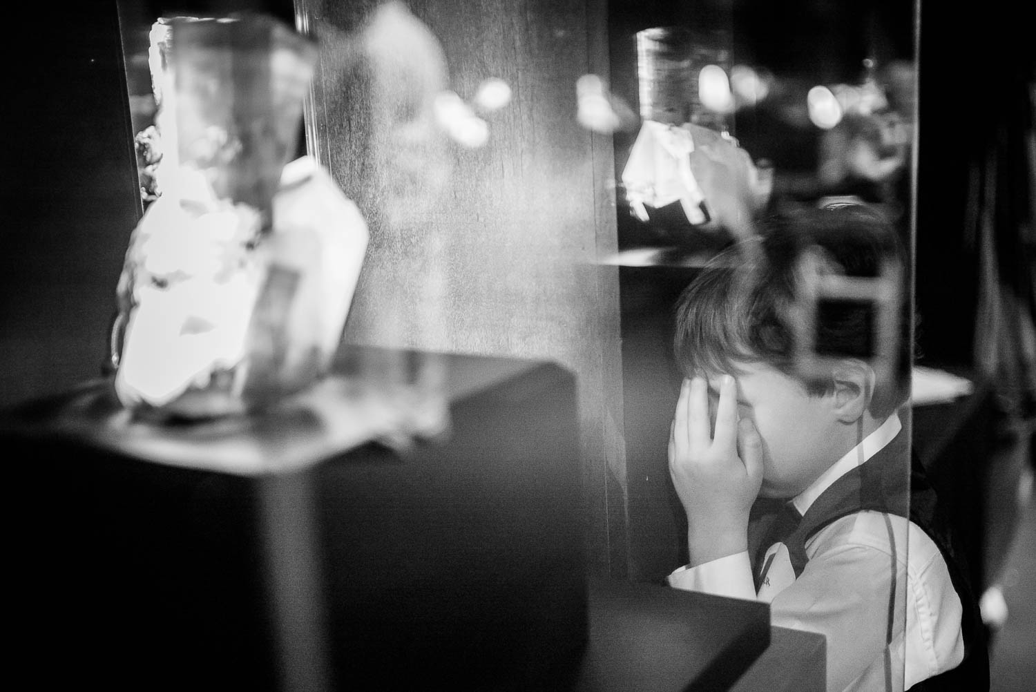 Boy covers eyes hide and seek Rehearsal dinner dinosaur image at Houston Museum of Natural Science by Philip Thomas Photography