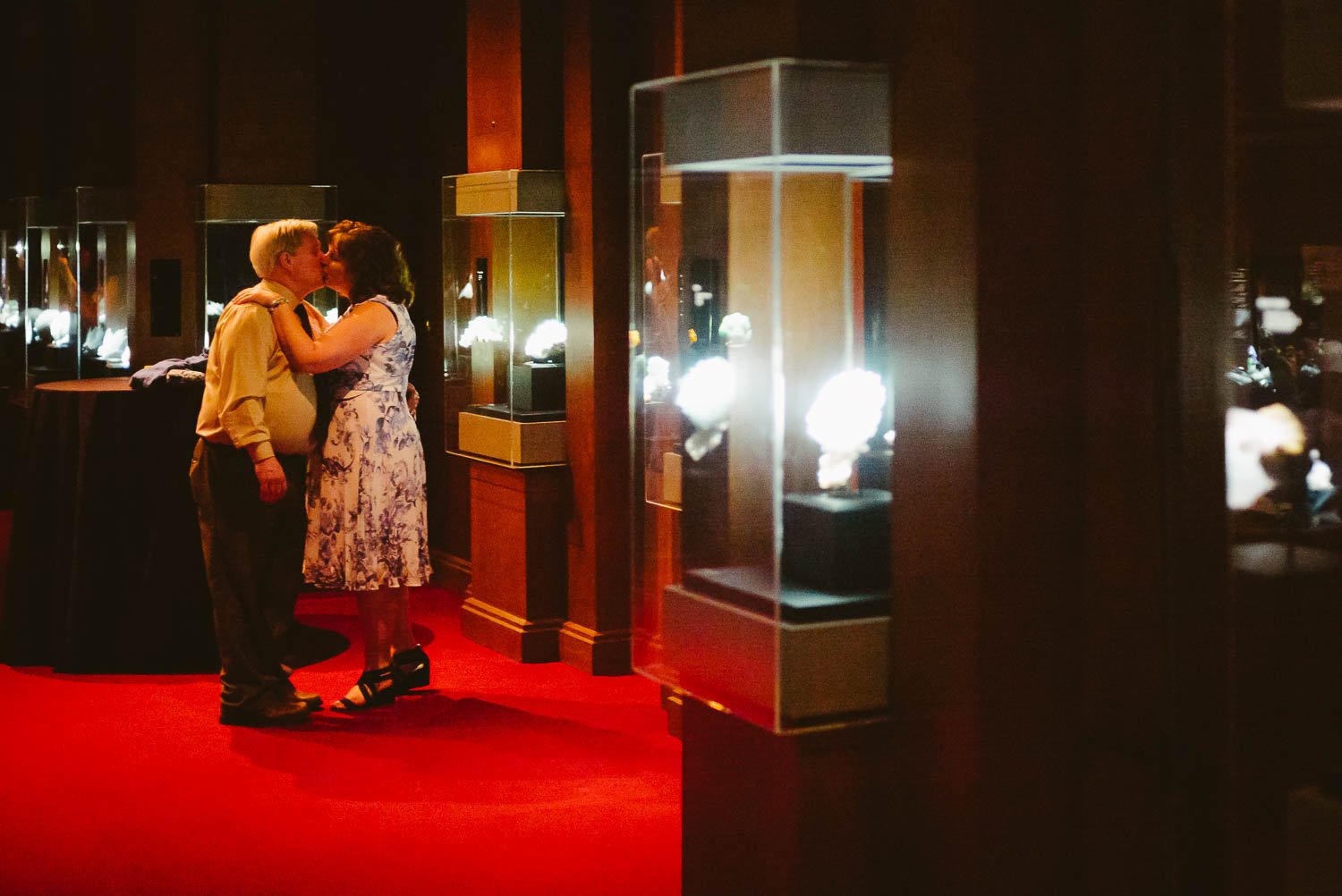 Older couple share a dance and a kiss at a Rehearsal dinner dinosaur image at Houston Museum of Natural Science by Philip Thomas Photography