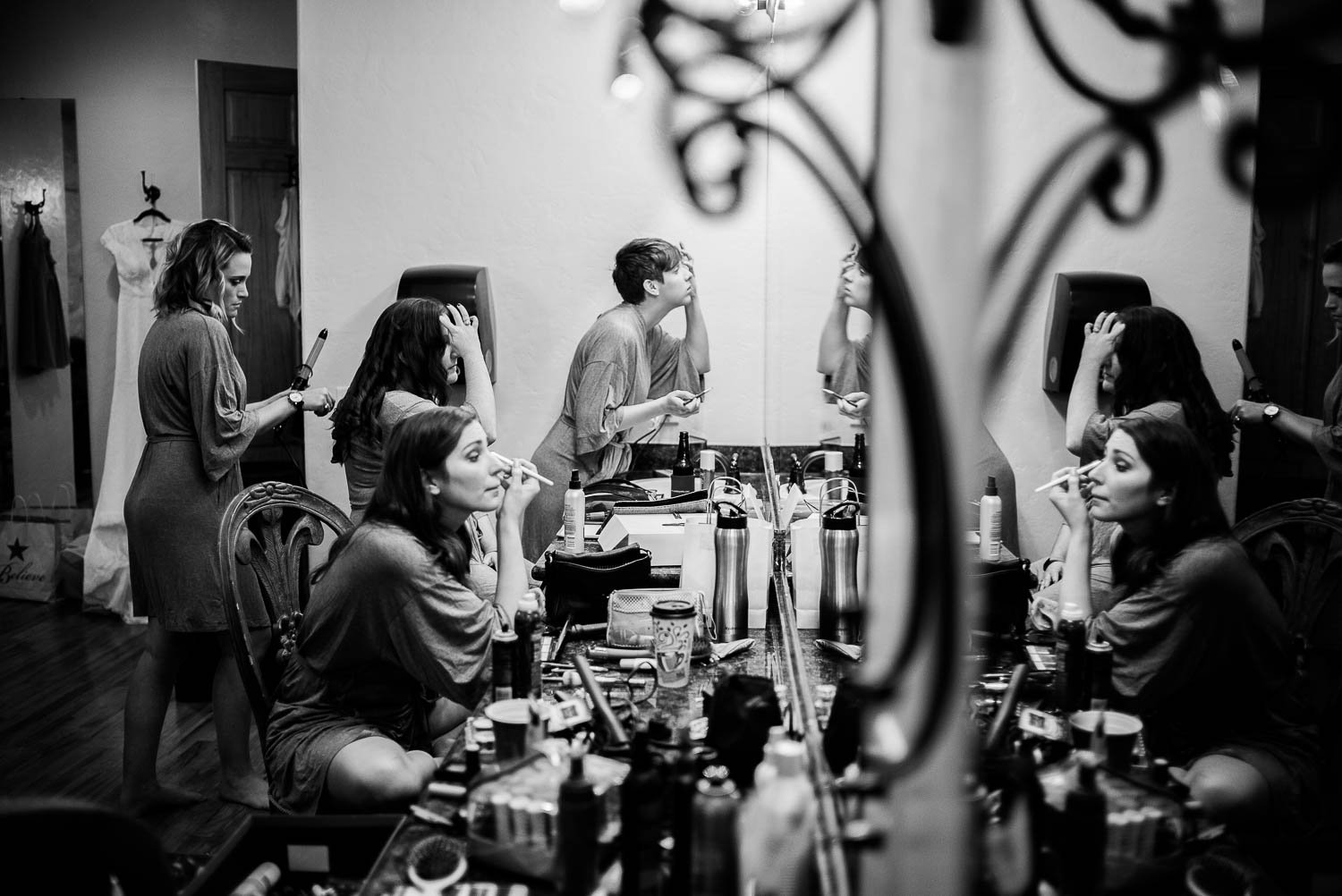 Bridesmaids shown getting ready in a mirror reflection Pecan Springs Houston Texas photo by Philip Thomas Photography