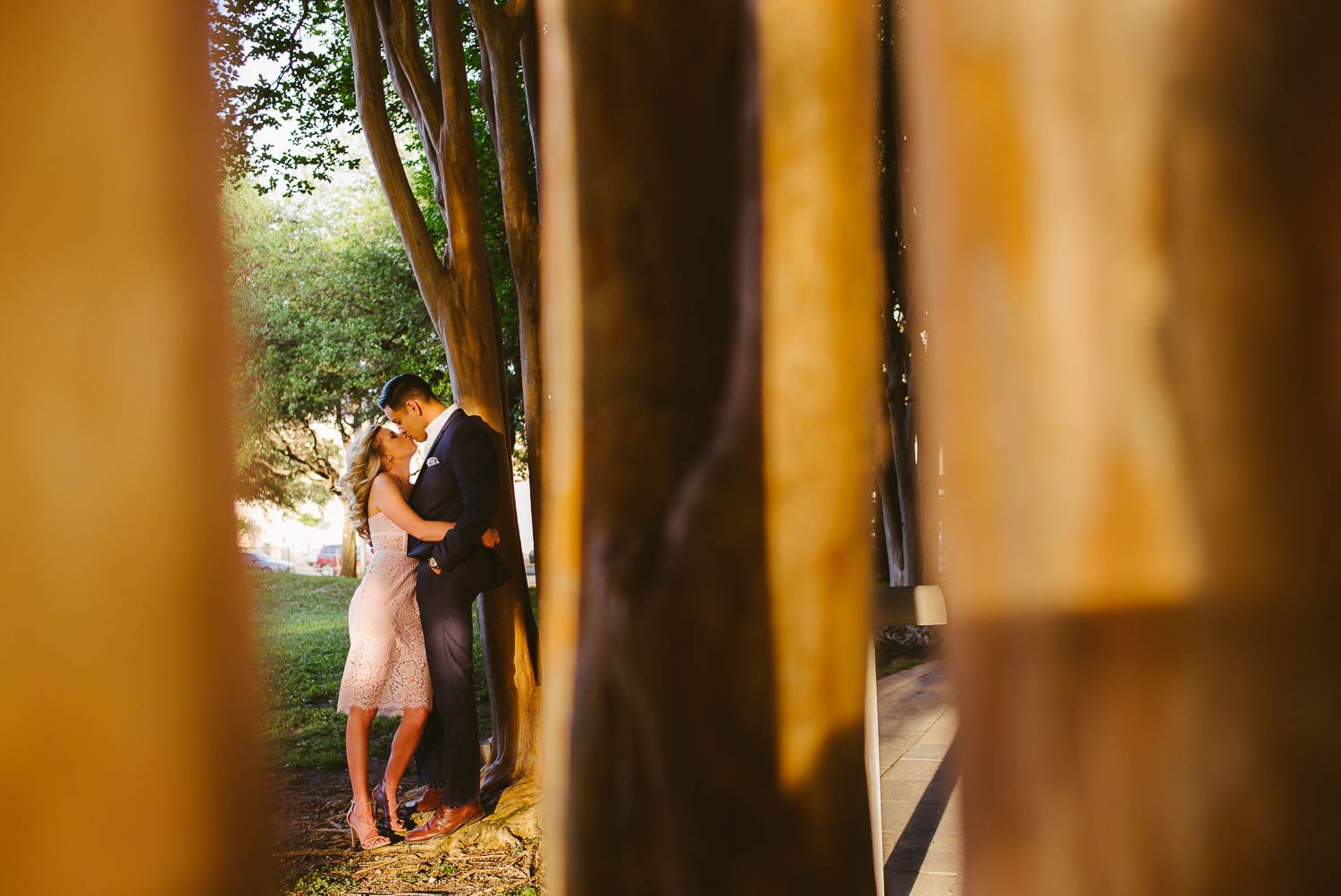 Couple downtown engagement shoot in San Antonio Texas leaning against tree