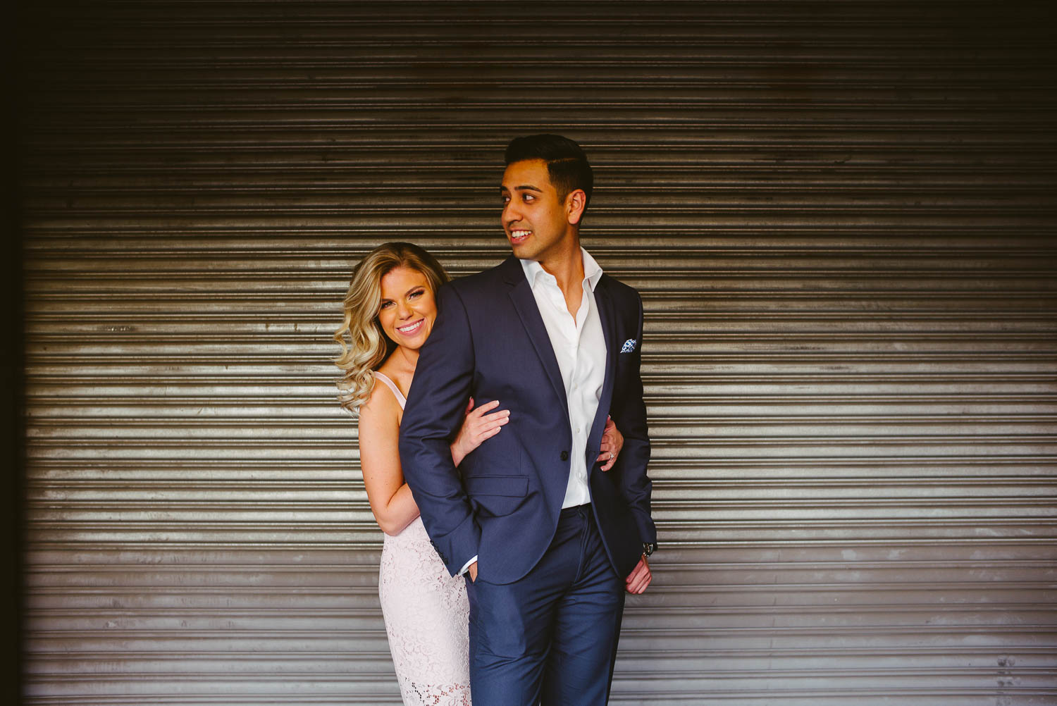 Couples engagement session downtown San Antonio against a loading dock