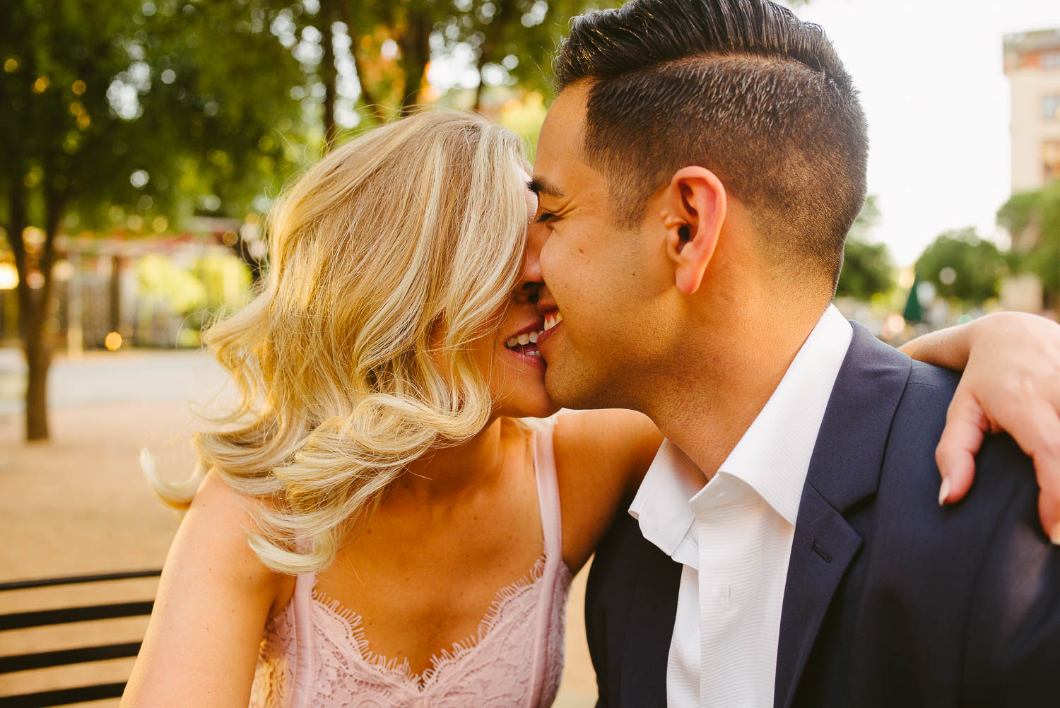 Couple kissing biting in San Fernando Plaza engagement session San Antonio Texas