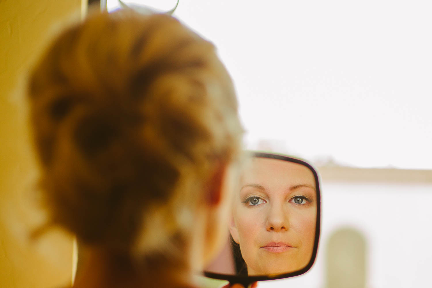 Looking in the mirror as bride completes makeup on her wedding day at Bell Tower on 34th Houston-Leica wedding photographer-Philip Thomas Photography